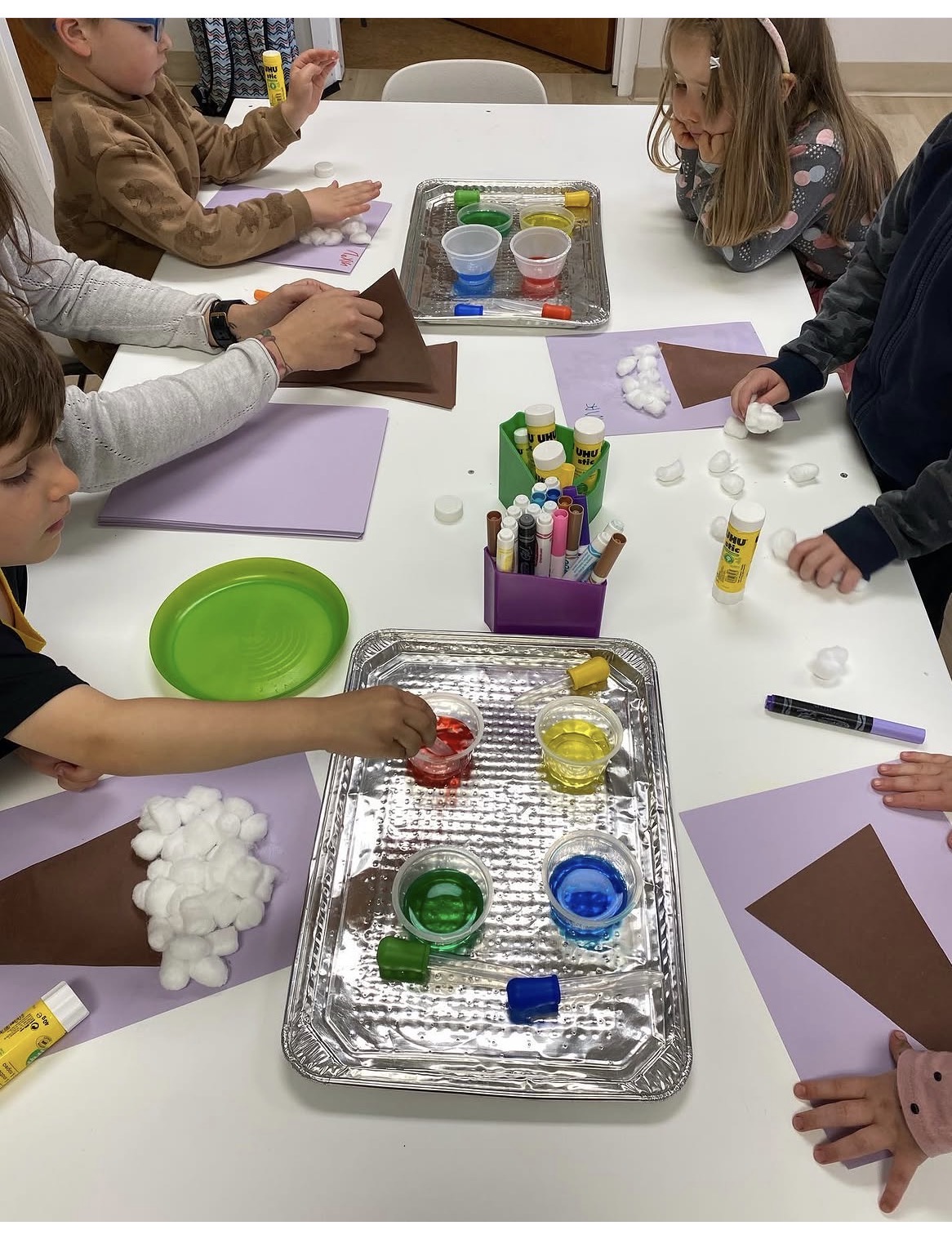 Little Me children exploring a colourful hands-on classroom activity